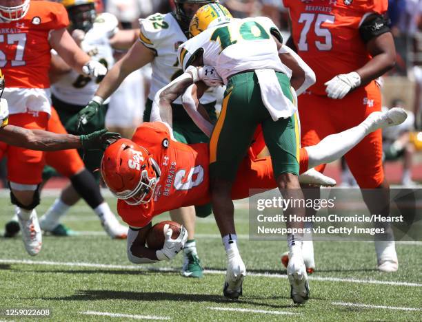 Sam Houston State running back Noah Smith is stopped just short of the goal line by North Dakota State safety Dom Jones during the first quarter of a...