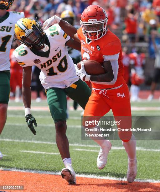 Sam Houston State running back Noah Smith runs past North Dakota State safety Dom Jones into the end zone for a 23-yard touchdown reception during...