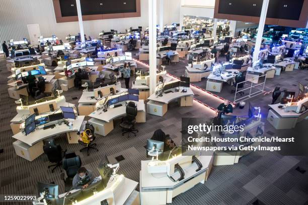 Communications officers work in the Harris County 911 Call Center Tuesday, May 18, 2021 in Houston. Harris County is doing a pilot program on Shot...