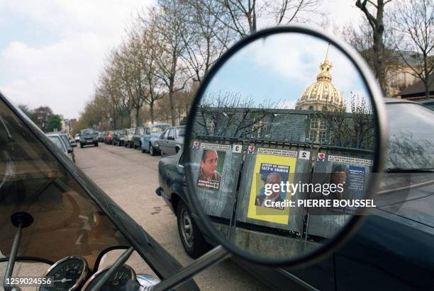 Presidential elections posters , glued on election billboards, are reflected in a motorcycle's rearview mirror in Paris street, 13 April 1995, ten...