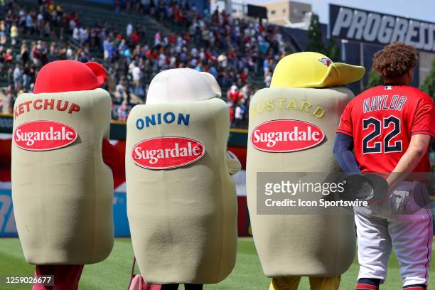 Cleveland Guardians first baseman Josh Naylor stand for the National Anthem with Cleveland Guardians mascots Ketchup, Onion and Mustard prior to the...