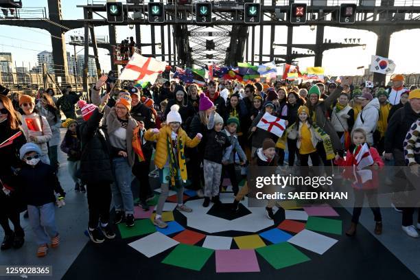 Participants march as they take part in the "Unity Celebrations", which marks the 25-day countdown until the start of the Australia and New Zealand...