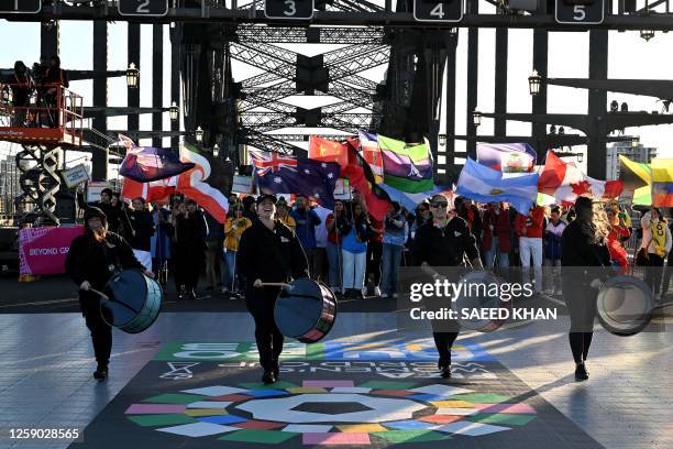 Participants march as they take part in the "Unity Celebrations", which marks the 25-day countdown until the start of the Australia and New Zealand...
