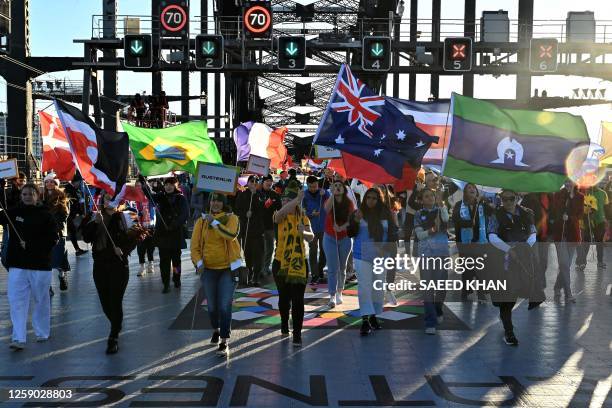 Participants march as they take part in the "Unity Celebrations", which marks the 25-day countdown until the start of the Australia and New Zealand...