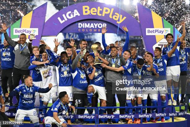 Millonarios' players celebrate with the trophy after defeating Atletico Nacional during the Colombian First Division Football Championship final...