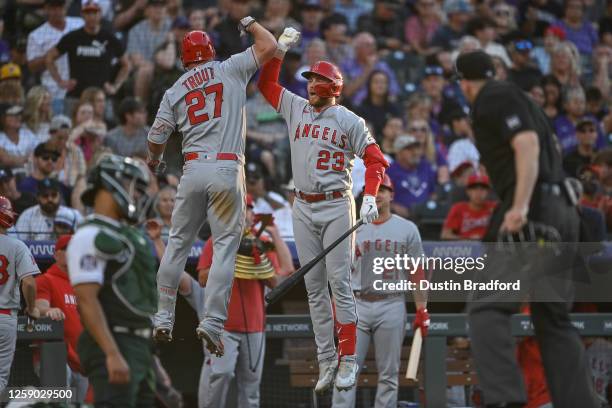 Mike Trout of the Los Angeles Angels celebrates with Brandon Drury after hitting a third inning solo homerun in a game against the Colorado Rockies...