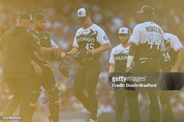 Chase Anderson of the Colorado Rockies is relieved by Bud Black in the third inning of a game against the Los Angeles Angels at Coors Field on June...