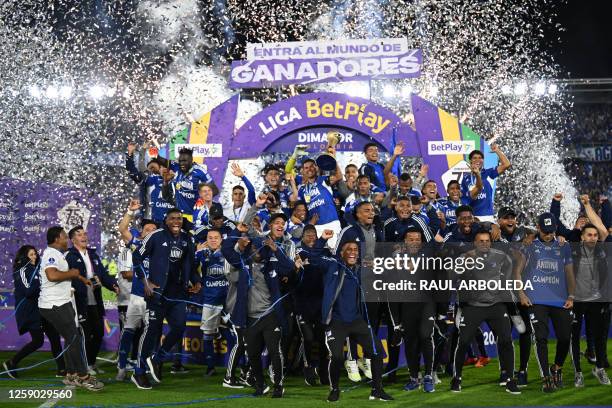 Millonarios' players celebrate with the trophy after defeating Atletico Nacional during the Colombian First Division Football Championship final...