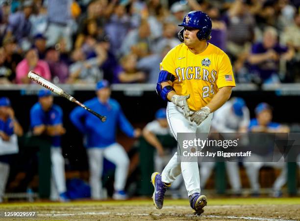 Cade Beloso of the LSU Tigers flips his bat after hitting a home run during the 11th inning of Game 1 of the NCAA College World Series baseball...