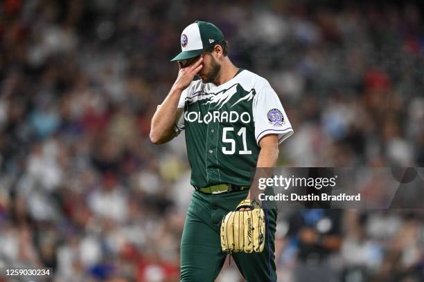 Karl Kauffmann of the Colorado Rockies walks off the field after pitching in the eighth inning of a game against the Los Angeles Angels at Coors...