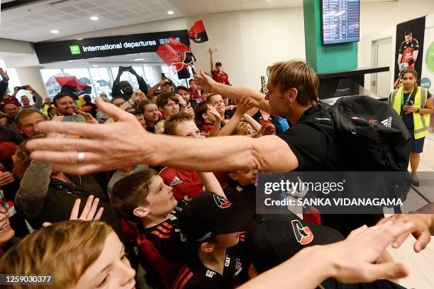 Crusaders' coach Scott Robertson greets the fans at Christchurch Airport on June 25, 2023 upon the return of the Crusaders team a day after winning...