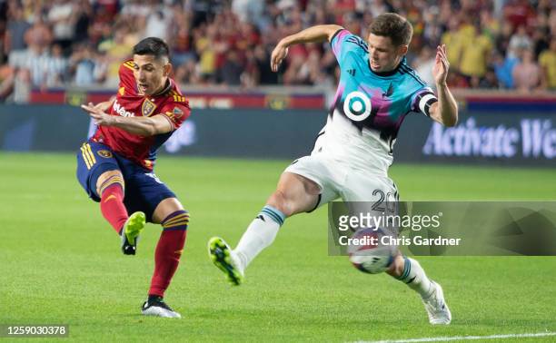 Jefferson Savarino of Real Salt Lake shoots the ball agaisnt Wil Trapp of Minnesota United during the second half of the their game at America First...