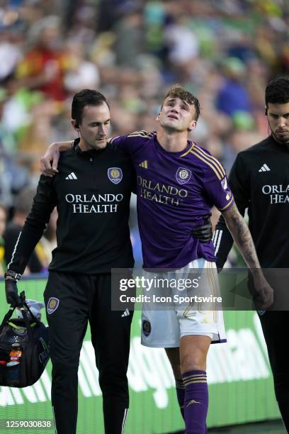 Orlando City defender Michael Halliday gets helped off the field during an MLS matchup between the Seattle Sounders and Orlando City SC on June 24,...