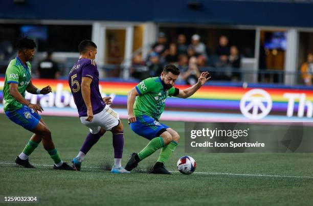 Seattle Sounders midfielder João Paulo fights to control the ball against Orlando City midfielder César Araújo during an MSL match between the...