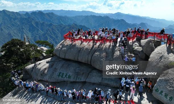 This aerial photo taken on June 23, 2023 shows visitors on the Huashan Mountain in Weinan, northwest China's Shaanxi Province,