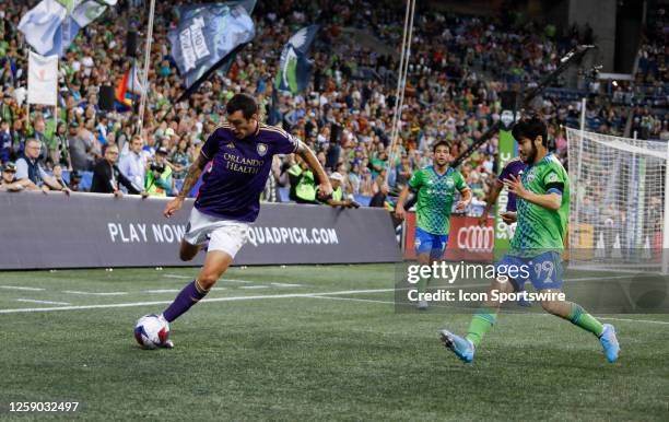 Orlando City defender Kyle Smith tries to clear the ball past Seattle Sounders midfielder Dylan Teves during an MSL match between the Seattle...