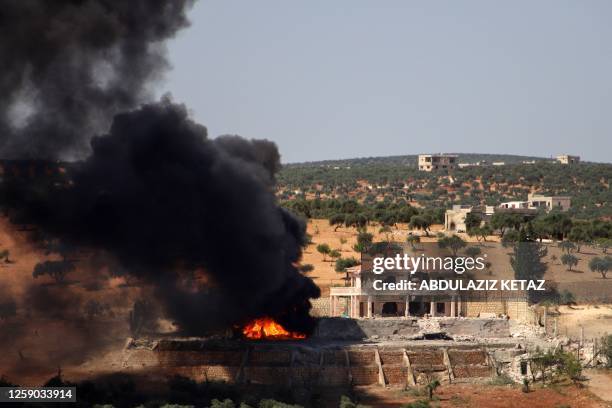 Plume of smoke rises from a building following a reported Russian air strike on Syria's northwestern rebel-held Idlib province, on June 25, 2023. The...