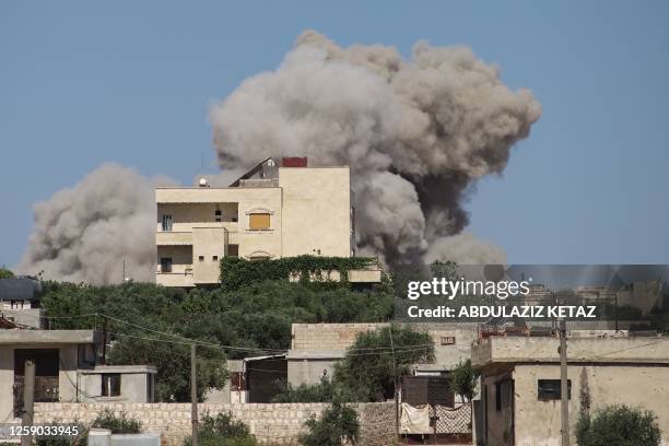 Plume of smoke rises from a building following a reported Russian air strike on Syria's northwestern rebel-held Idlib province, on June 25, 2023. The...