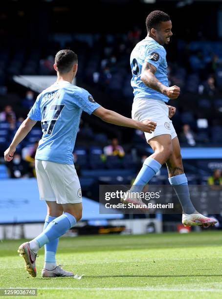 Gabriel Jesus of Manchester City celebrates with teammate Phil Foden after scoring the opening goal during the Premier League match between...