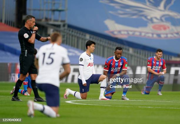 Heung-Min Son of Tottenham Hotspur and Jordan Ayew of Crystal Palace 'take the knee' alongside team mates prior to the Premier League match between...