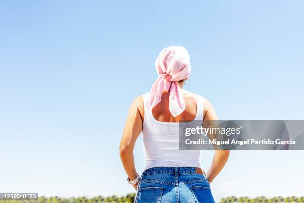rear view of a mature woman with cancer with a mask on the arm - stock photo. - cancerland 2019 bildbanksfoton och bilder