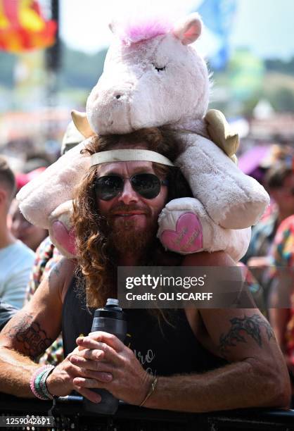 Festival goer with a cuddly toy attends the concert at The Other Stage on day 5 of the Glastonbury festival in the village of Pilton in Somerset,...