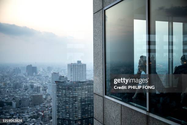 People visit Tokyo Metropolitan Government Building Observatories in Tokyo on June 25, 2023.