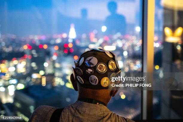 Man looks at the city skyline from Tokyo Metropolitan Government Building Observatories in Tokyo on June 25, 2023.