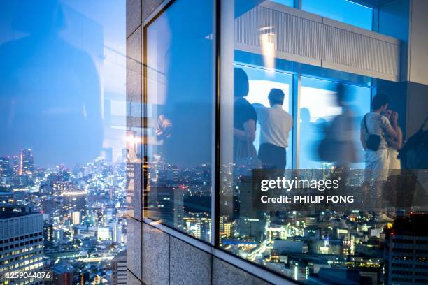 People visit Tokyo Metropolitan Government Building Observatories in Tokyo on June 25, 2023.