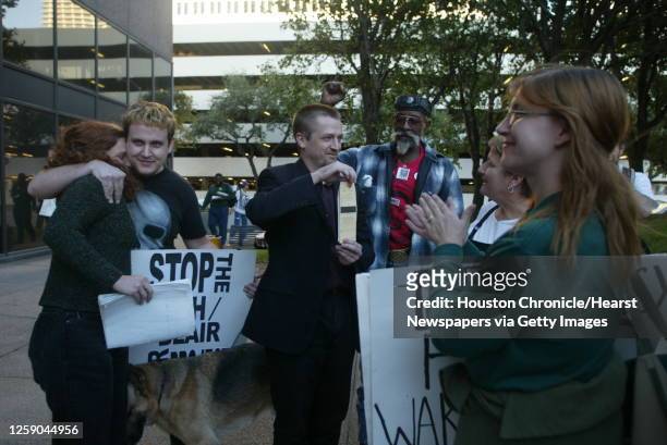 Mark Waller, center, displays a citation he received after refusing to leave Kay Bailey Hutchison's office during an antiwar protest at the George...