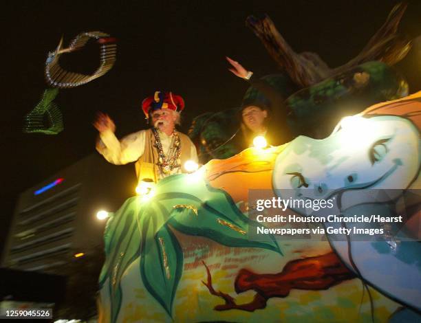 Mardi Gras revelers toss beads off of a float at the Grand Momus Parade in front of the Tremont House at Mardi Gras Galveston March 1,2003. James...