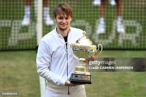 Winner Kazakhstan's Alexander Bublik poses with his trophy after winning the men's singles final tennis match of the ATP 500 Halle Open tennis...