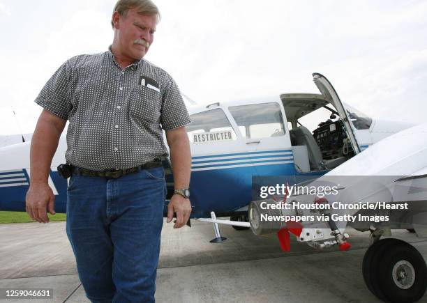 Chief Pilot Malcom Williams looks at a rotary atomizer on a Piper Aztec twin engine airplane at Sugar Land Regional Airport that will be used to...