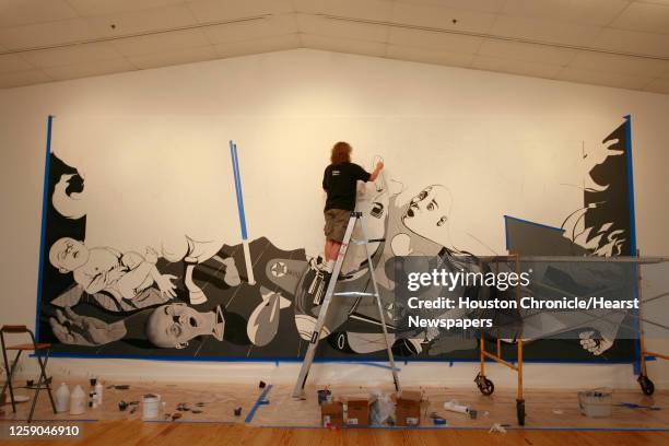 Ron English is painting a mural of Picasso's Guernica at the Station Museum of Contemporary Art in Houston,Texas June 22,2006. James Nielsen