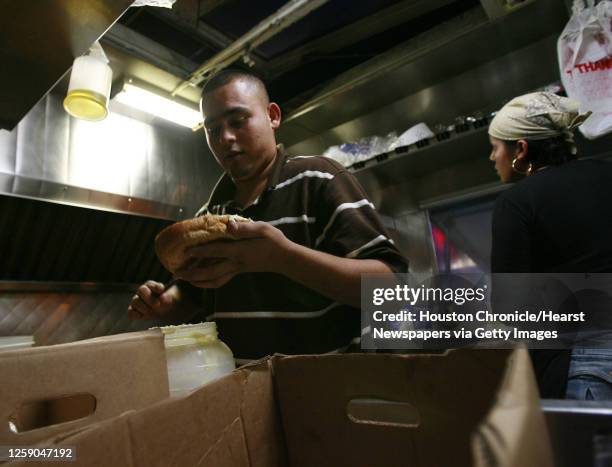 Jesse Salinas 17 yrs.) of McAllen, Texas prepares a torta in the Taqueria Sanchez mobile taco truck on Veterans Memorial Boulevard in Metarie,...