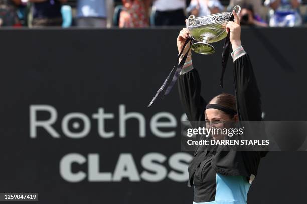 Latvia's Je?ena Ostapenko celebrates with the trophy after winning against Czech Republic's Barbora Krejcikova at the end of their women's singles...