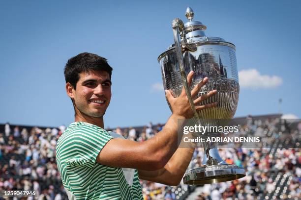 Spain's Carlos Alcaraz celebrates with the trophy after winning against Australia's Alex de Minaur at the end of their men's singles final match at...