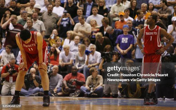 The Houston Rockets Yao Ming and Tracy McGrady stand on the court near the end of the fourth quarter of game six in the first round of the NBA...