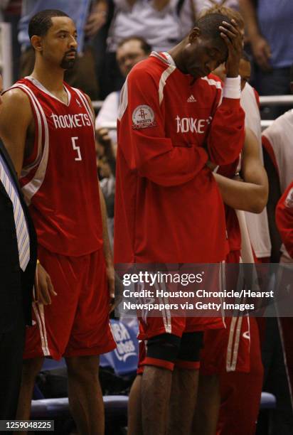 The Houston Rockets Dikembe Mutombo holds his hand on his head while teammate Juwan Howard looks on near the end of the fourth quarter of game six in...