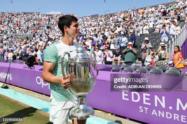 Spain's Carlos Alcaraz celebrates with the trophy after winning against Australia's Alex de Minaur at the end of their men's singles final match at...