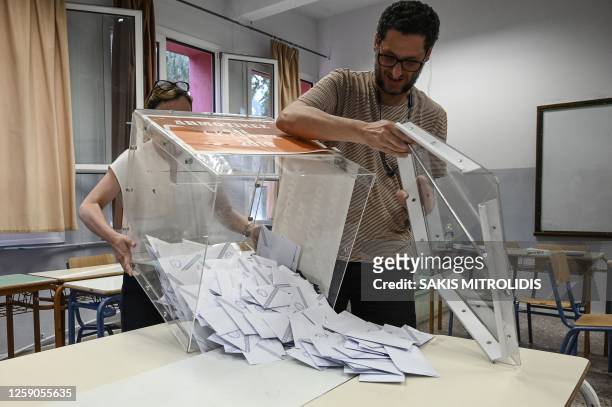 Election officials empty a ballot box to count the votes at a polling station during general elections in Thessaloniki, on June 25, 2023. Greek...