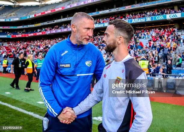 Dublin , Ireland - 25 June 2023; Laois manager Billy Sheehan, left, shakes hands with Down manager Conor Laverty after the Tailteann Cup Semi Final...
