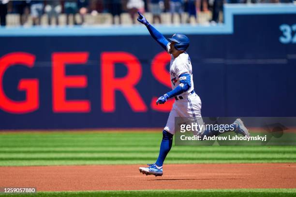 George Springer of the Toronto Blue Jays celebrates his home run against the Oakland Athletics during the first inning in their MLB game at the...