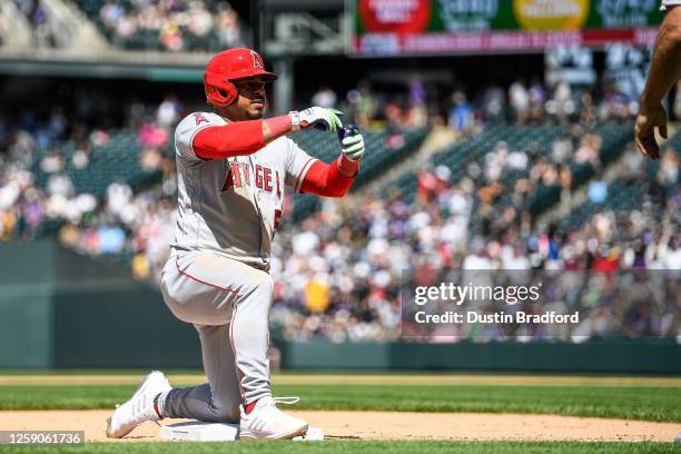 Eduardo Escobar of the Los Angeles Angels celebrates at third base with a ninth inning triple in a game against the Colorado Rockies at Coors Field...