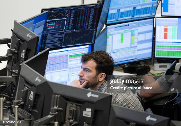 June 2023, Hesse, Frankfurt/Main: A stock trader follows the price development on his monitors in the trading room of Deutsche Börse. The DAX,...