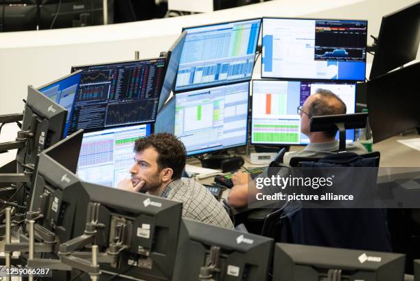 June 2023, Hesse, Frankfurt/Main: Stock traders follow the price development on its monitors in the trading hall of Deutsche Börse. Germany's leading...