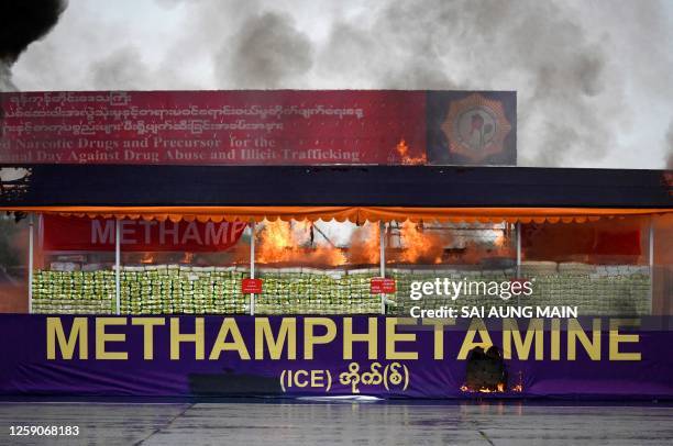 Burning pile of seized illegal methamphetamine is seen during a destruction ceremony to mark the "International Day against Drug Abuse and Illicit...