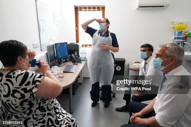 British Prime Minister Rishi Sunak and Health Secretary Steve Barclay speaking to patient Susan as she takes a Spirometry Test during a visit to...