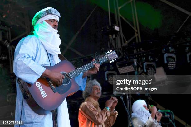 Abdallah Ag Alhousseyni with a collective of Tuareg musicians from the Sahara Desert region of northern Mali, performing live on stage at Glastonbury...