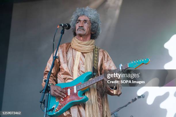 Ibrahim Ag Alhabib with a collective of Tuareg musicians from the Sahara Desert region of northern Mali, performing live on stage at Glastonbury...